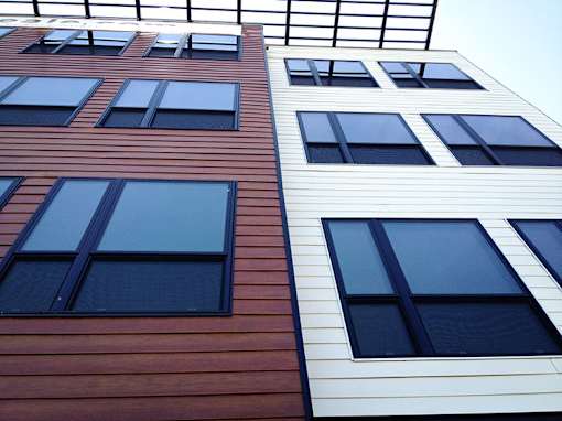 Modern exterior facade with horizontal siding and large windows at 68 Beale Apartments, Quincy, MA